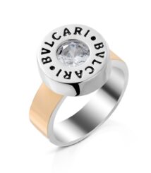 Bvlgari ring with a central diamond-like stone in a round bezel and a two-tone band (silver and rose gold).