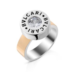 Bvlgari ring with a central diamond-like stone in a round bezel and a two-tone band (silver and rose gold).