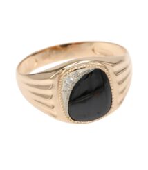 Gold signet-style ring with a large black cabochon stone and small diamonds along the bezel