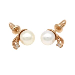 Gold earrings with round white pearls and small diamond accents, set in a filigree gold design for a feminine, vintage look