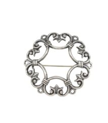 Circular silver decorative brooch finding with ornate scrollwork and a straight pin across the middle.