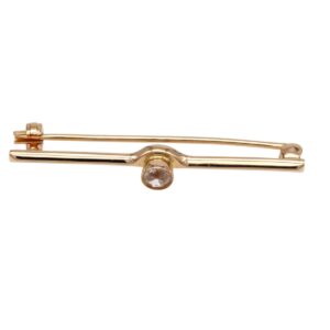 Gold-tone tie clip with a round gemstone centerpiece