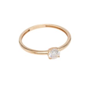 Gold solitaire engagement ring with a round diamond set in four prongs on a slim gold band
