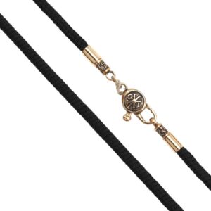 Black braided cord necklace with a gold-tone clasp and small round pendant with decorative emblem.