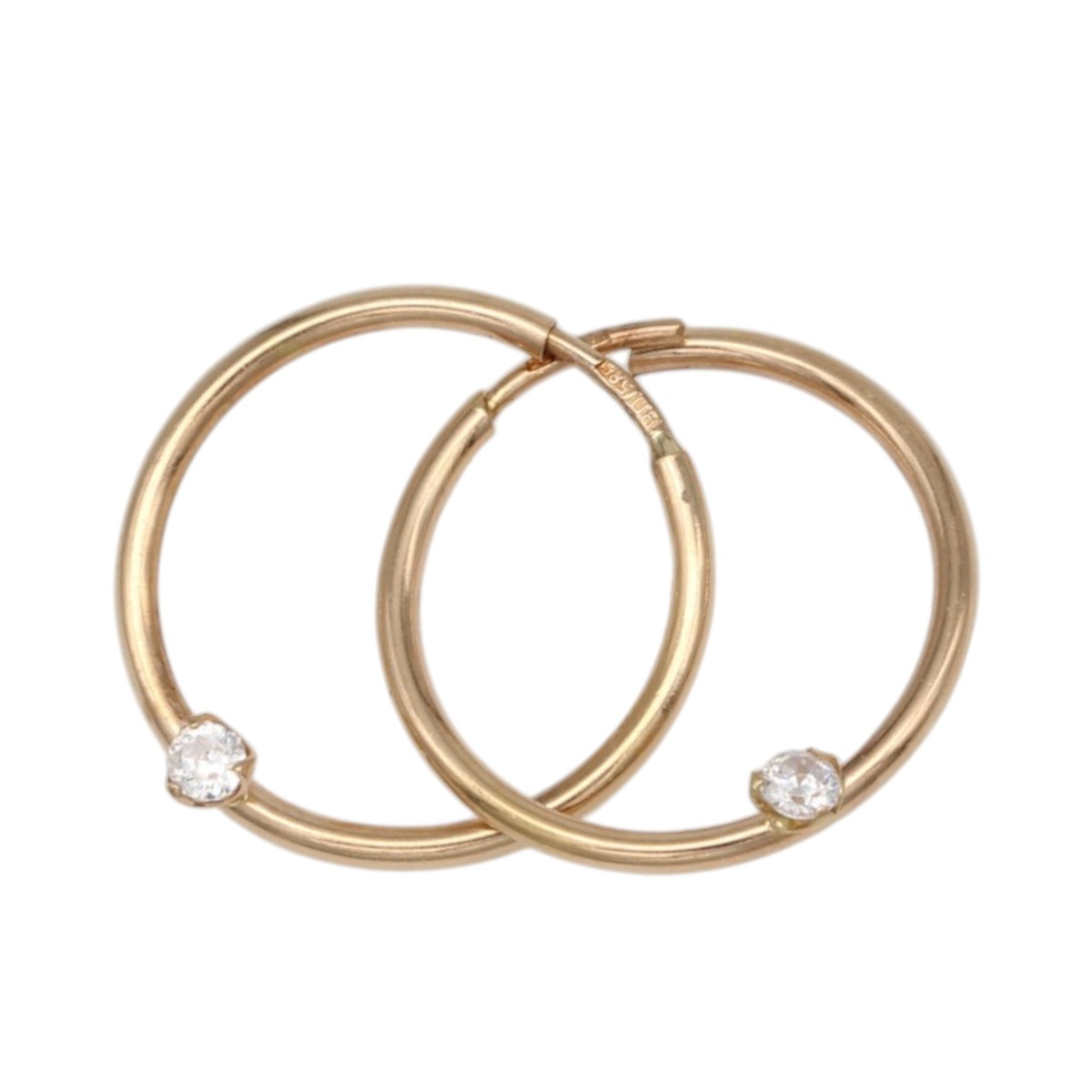4f159a8076a23fab2892378a60a43ec4jpg - Mezola OÜ Two overlapping rose-gold hoop earrings, each with a small diamond at the bottom edge.