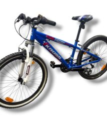 Blue mountain bike with front suspension, knobby tires, and a blue frame marked with 'KROS' on the downtube.