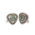 Pair of ornate heart-shaped silver earrings with green cabochon stones and intricate filigree detailing.