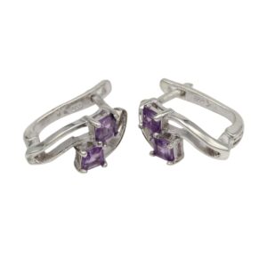 Pair of silver earrings featuring two rectangular purple gemstones set in prongs, on a curved metal design.