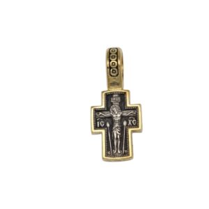 Gold and black crucifix pendant showing Jesus on the cross with a decorative gold border and a square-pattern bail above