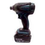 Cordless Makita drill with blue and black body, 18V Li‑ion battery attached, viewed from the side.