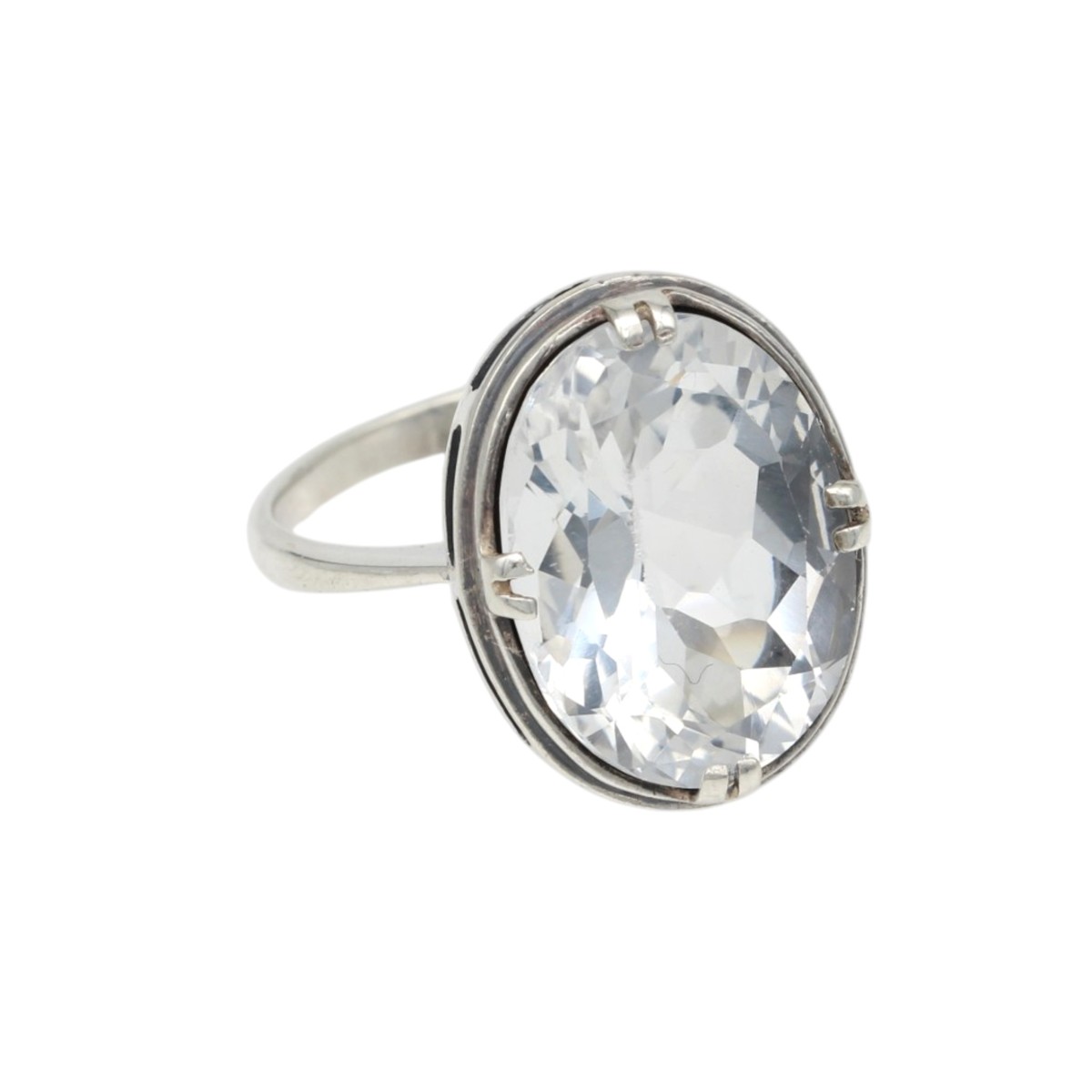 82bae599e284f8fb608ea7ac5f6fae4bjpg - Mezola OÜ Oval clear gemstone ring with a silver band and prong setting