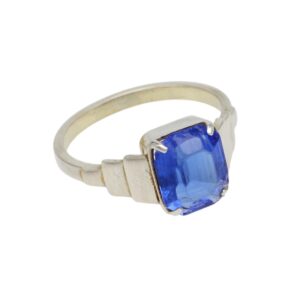 Silver ring with a square-cut blue gemstone held by four prongs on a simple band.