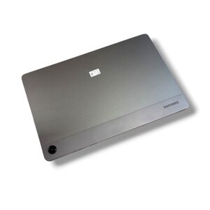 Back of a silver Samsung tablet, featuring a circular camera in the lower-left corner, shown at an angle.