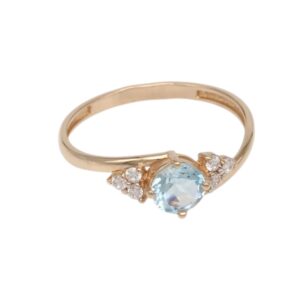 Rose gold ring with a pale blue oval center stone and small diamond accents on each side