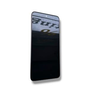 Tilted black smartphone on a white background with a visible front camera at the top edge.