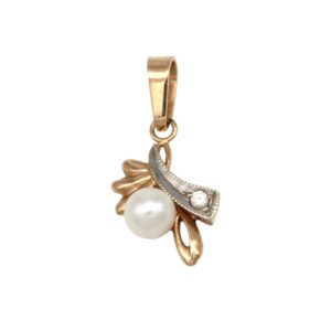 Gold pendant featuring a white pearl and a small diamond, set in a decorative floral motif with a curved, leaf-like design