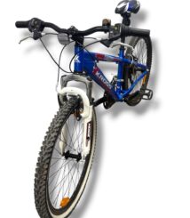 Blue Kross mountain bike with white Zoom front suspension, knobby tires, and a front light, angled from the front-left.