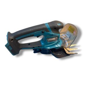 Blue cordless angle grinder with a protective guard and cutting disc, lying on its side.