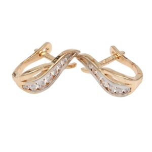 Gold-tone hoop earrings featuring a twisted two-tone design with a row of small diamonds along the inner curve.
