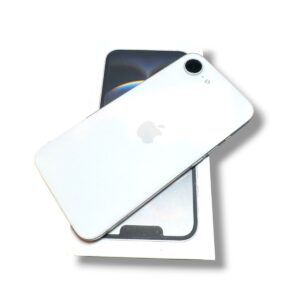White iPhone with Apple logo resting on its box, showing the rear camera in the top corner.