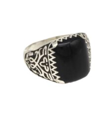 Silver ring with a large black onyx stone and geometric tribal engravings along the band.