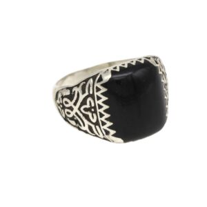 Silver ring with a large black onyx stone and geometric tribal engravings along the band.