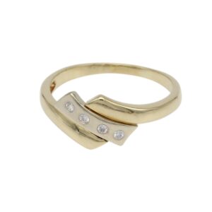 Two-tone gold ring with a curved band and three small diamonds set along a silver-toned plate at the front