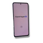Phone screen displaying Xiaomi HyperOS branding on a pink gradient background.