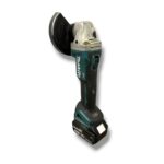 Cordless Makita angle grinder with a circular abrasive disc and battery pack.