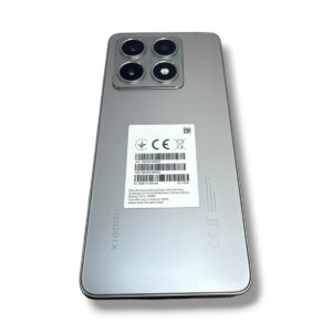 Back of a silver Xiaomi smartphone with a quad-camera module and a white barcode label on the center of the back area