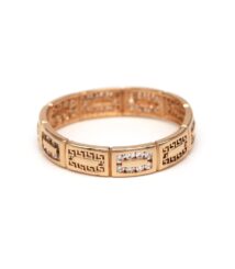 Rose gold ring with engraved geometric panels and a row of diamonds on the centerpiece.
