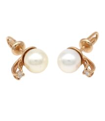 Gold-tone pearl stud earrings with a small diamond accent on each side