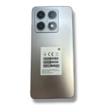 Back view of a silver smartphone with a rectangular quad-camera module in the top-left corner and a label on the back panel, no visible branding mentioned.
