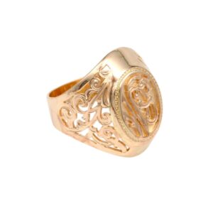Gold signet ring featuring intricate scrollwork and a raised oval bezel with decorative detailing on the sides.