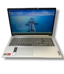Open silver Lenovo laptop shown from a slightly elevated angle with a blue ocean pier wallpaper on the screen.