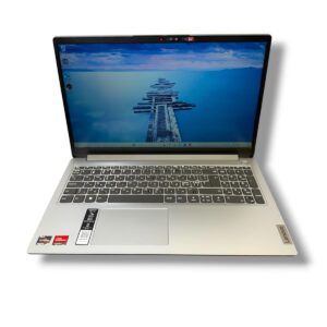 Open silver Lenovo laptop shown from a slightly elevated angle with a blue ocean pier wallpaper on the screen.