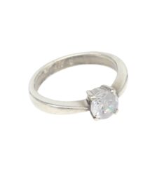 Silver solitaire engagement ring with a round-cut diamond in a four-prong setting on a smooth metal band