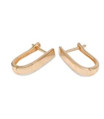 Gold curved hoop earrings with hinged backs on a white background