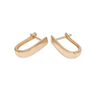 Gold curved hoop earrings with hinged backs on a white background
