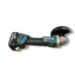 Cordless angle grinder with a battery pack, turquoise and black, facing right with a circular grinding disc.