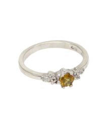 Silver ring featuring an oval yellow gemstone with small side diamonds on a plain band