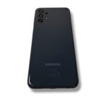Back of a dark Samsung smartphone with a quad-camera setup in the top-left corner.