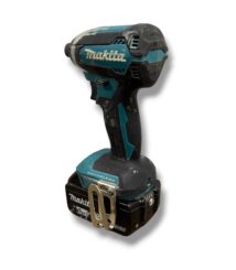 Makita cordless drill with 18V battery and belt clip, shown from the side, used and dusty.