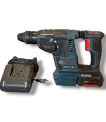 Cordless Bosch drill with battery pack and charging dock on a white background, used for drilling tasks.