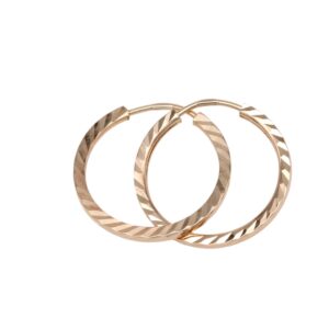 Rose-gold hoop earrings with a diagonal faceted pattern on a white background - two hoops overlapping