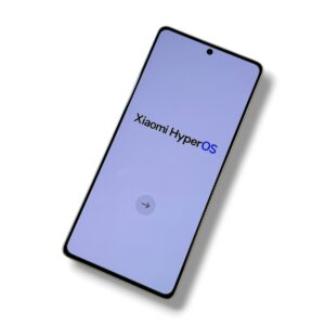 Tilted smartphone showing the Xiaomi HyperOS welcome screen on a lavender background.