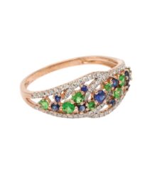 Rose gold ring with a curved, diamond-encrusted band and green emeralds and blue sapphires as colorful accents on the front.
