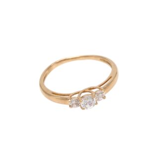 Gold ring with three clear stones arranged in a decorative cluster on the band