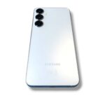 Back of a silver Samsung smartphone with three camera lenses in a vertical module at the top-left corner.