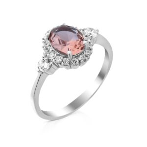 Oval pink center stone surrounded by a diamond halo on a silver ring, set in white gold or platinum.